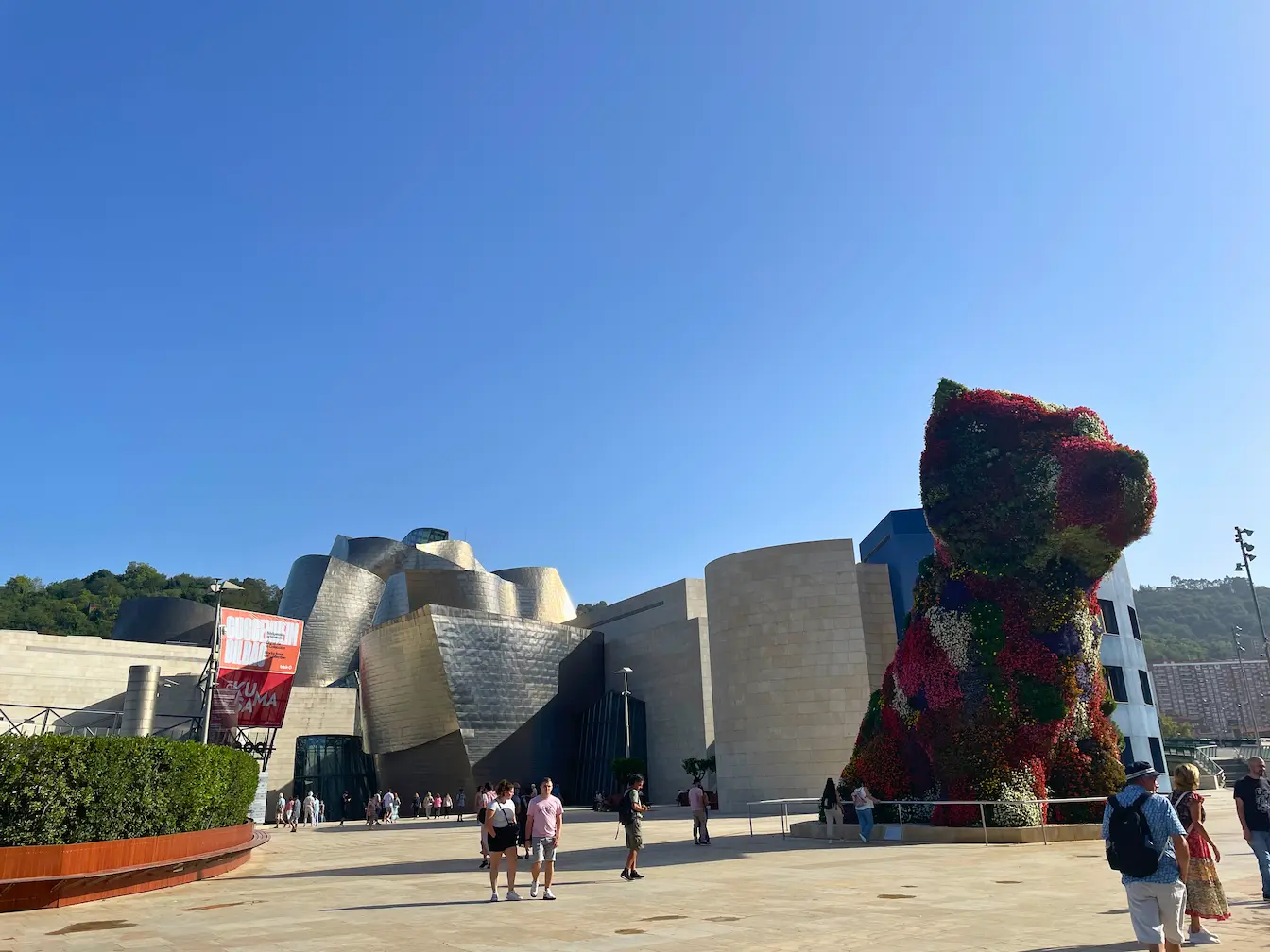 A view of Guggenheim museum in Bilbao from the front with the Puppy flower statue 