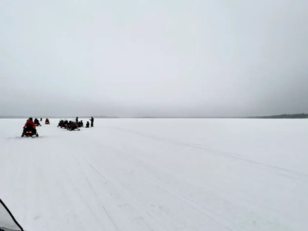 9 Winter Adventures in Lapland You Will Love - Around Europe Snowmobiles on a frozen lake in Laplnad