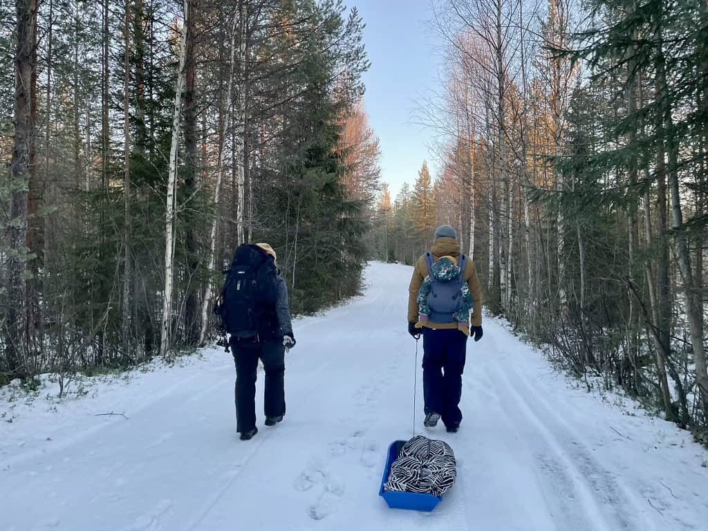 heading out for a winter walk near rovaniemi with a baby and a sledge